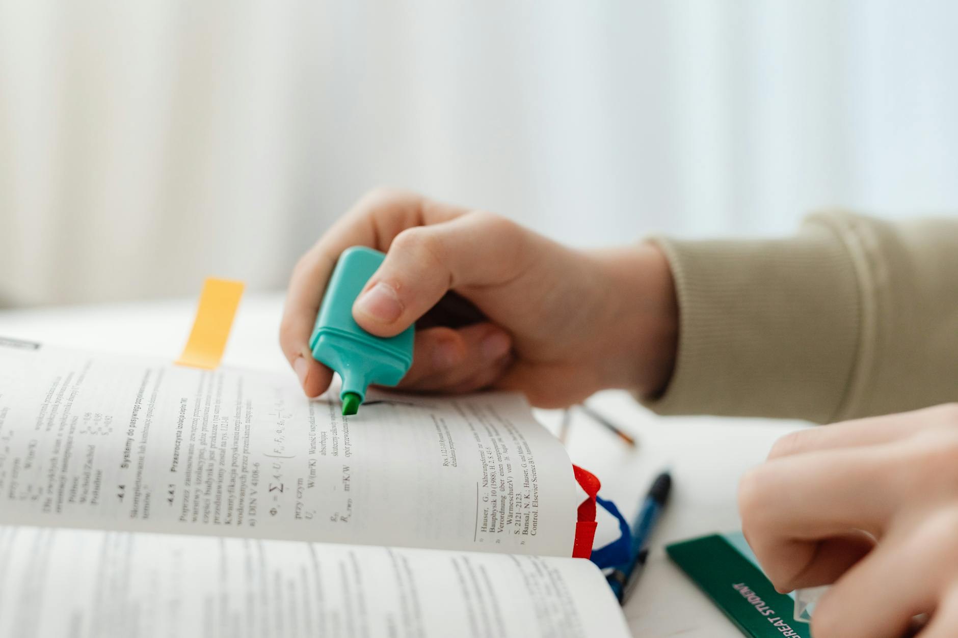 Annotated business books on desk with notes and highlights